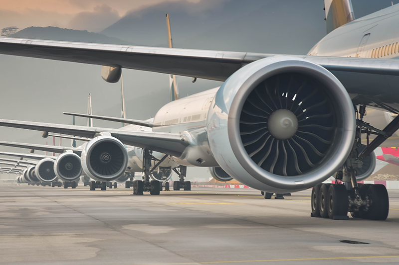 Row of aircraft lined up on an airport runway