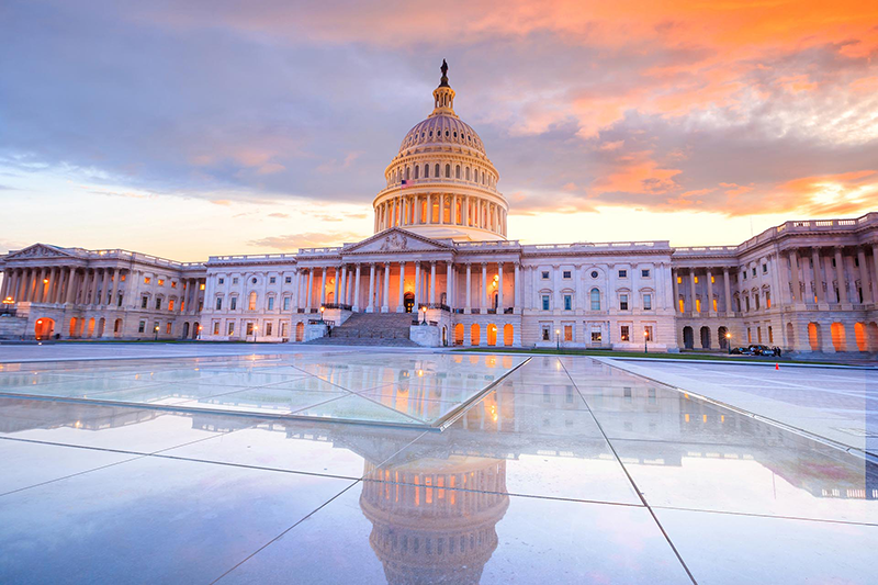 U.S. Capitol building at sunset with reflected plaza
